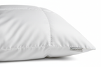 Close-up of soft duck down microfiber queen pillow with white cotton cover