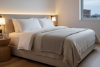 Pair of luxury duck down king pillows on neutral linen bedding